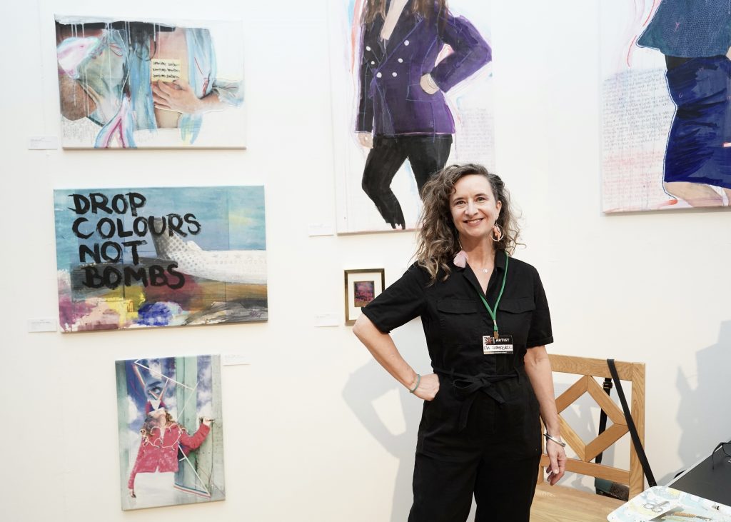 Eva Silberknoll in front of her artworks at the transformarte art fair 2025
