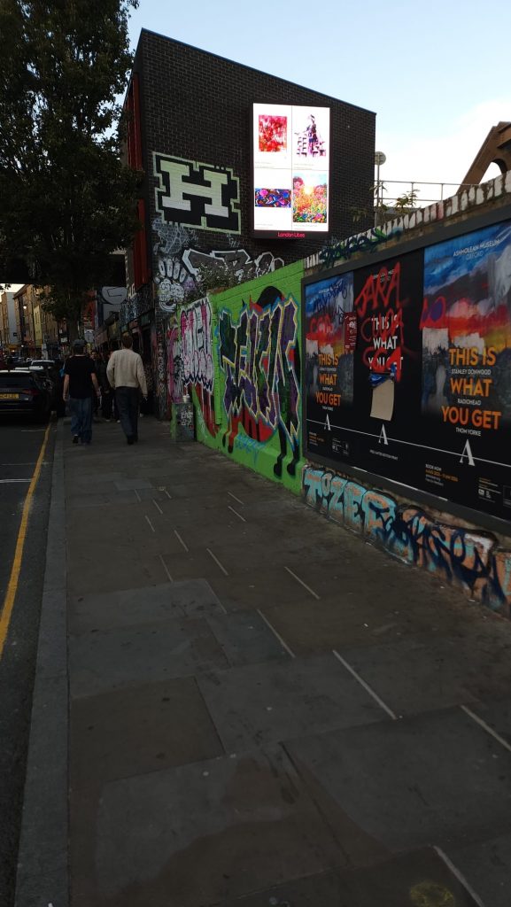the billboard showing artworks at night time